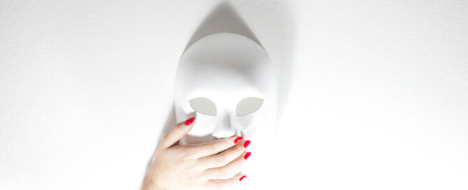 Mask with hand covering the mouth to silence someone by gaslighting