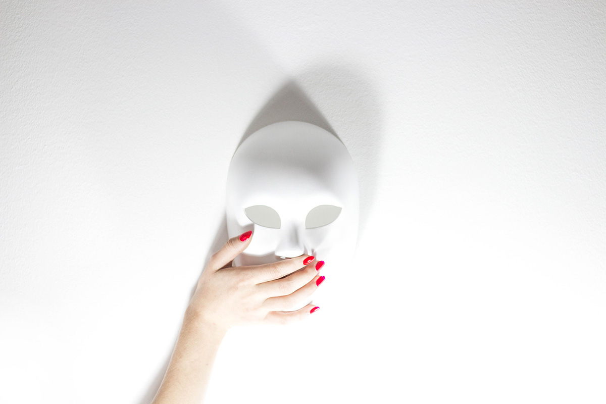Mask with hand covering the mouth to silence someone by gaslighting